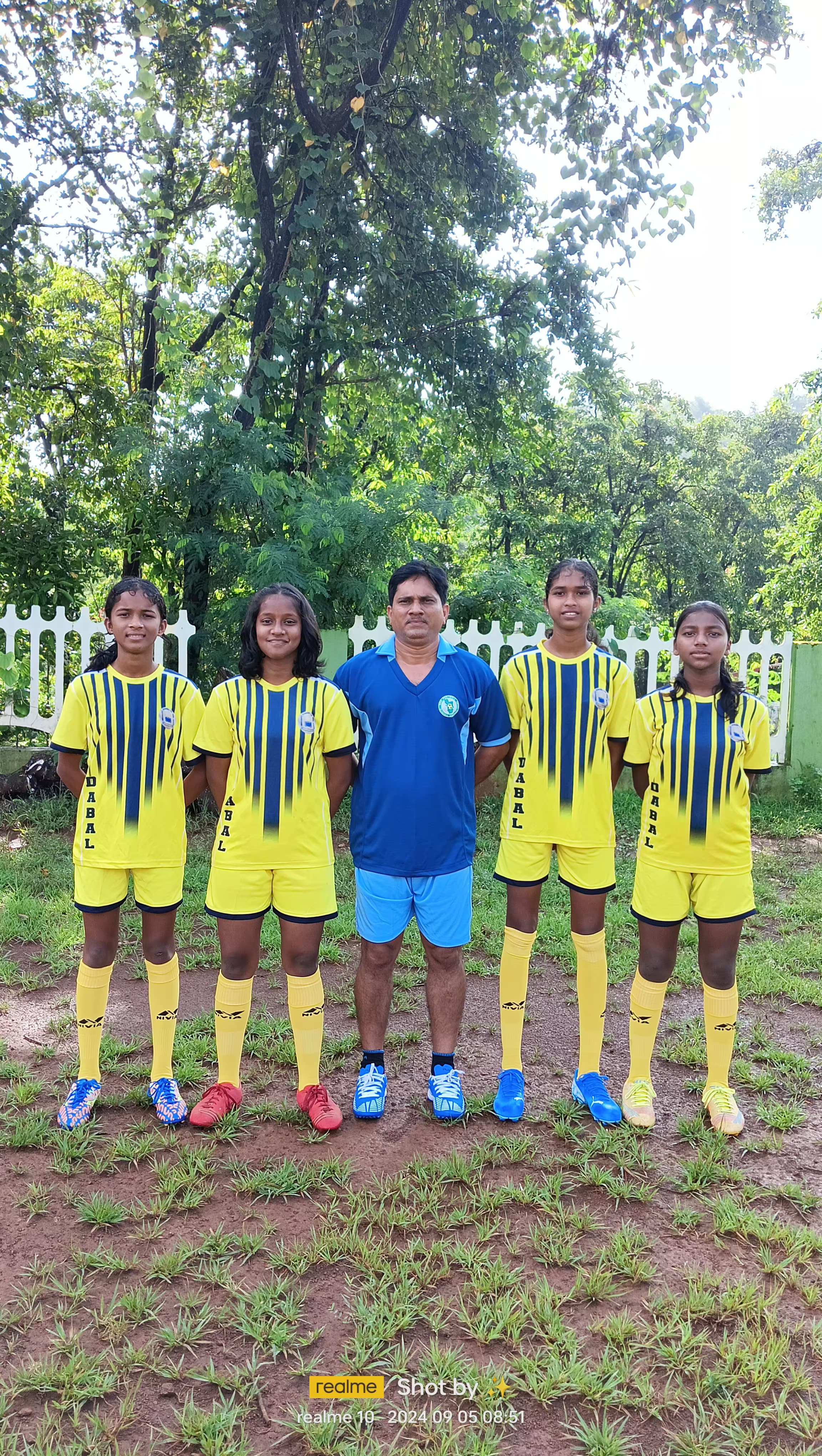 Coach Prajot Dharma Shirodkar with young GFDC trainees on the field.