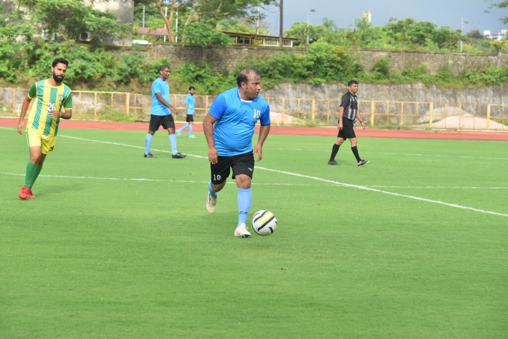 Action moment from the 10th anniversary match, with a midfielder dribbling the ball.