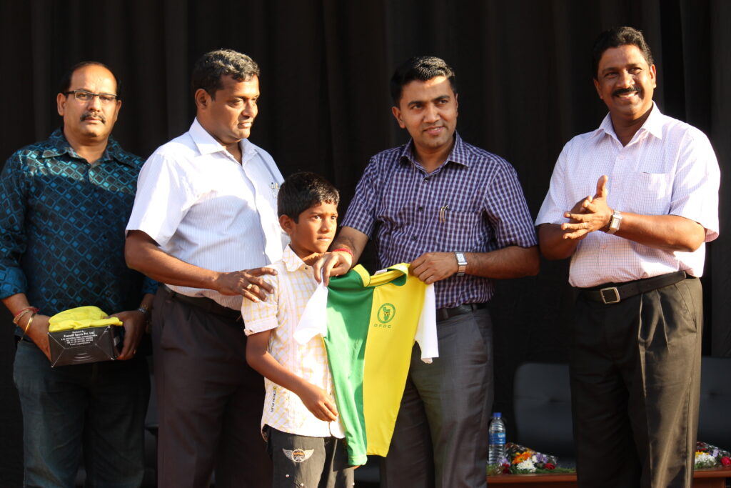 GFDC officials handing out kits to young footballers at a distribution event.